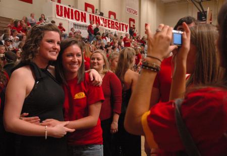 Senior Kirby Maxwell, the 2007 Homecoming Queen, poses with a friend during the halftime break.  - Photo by Neisha Fuson