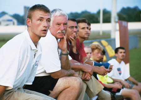 Jay Roberts, junior trainer; Bill Lean, father of Chris and Jeff Lean; Darin White, soccer coach and Kyle McDiarmid, junior midfielder, watch as the Bulldogs play Covenant College. - Photo by Kristen Hiller