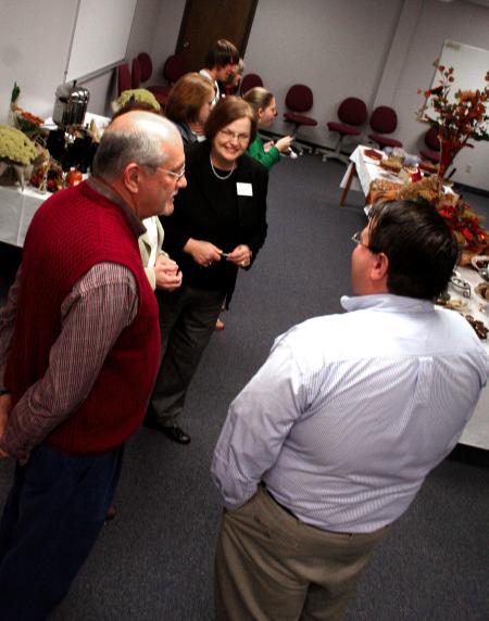Ann Singleton and Ken Newman talks with alumnus John Gross and others at the School of Education's homecoming reception. - Photo by Kristi McMurry Woody