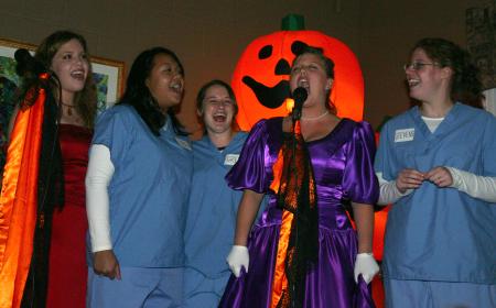 Sophomore Amy Brown belts out a karaoke song along with friends for backup. - Photo by Stephanie Schroeder
