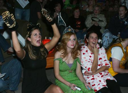Freshmen Bonnie Clark, Emily Pedan and Morgan Swann cheer and listen to the karaoke singers during Costume Coffee House. - Photo by Stephanie Schroeder