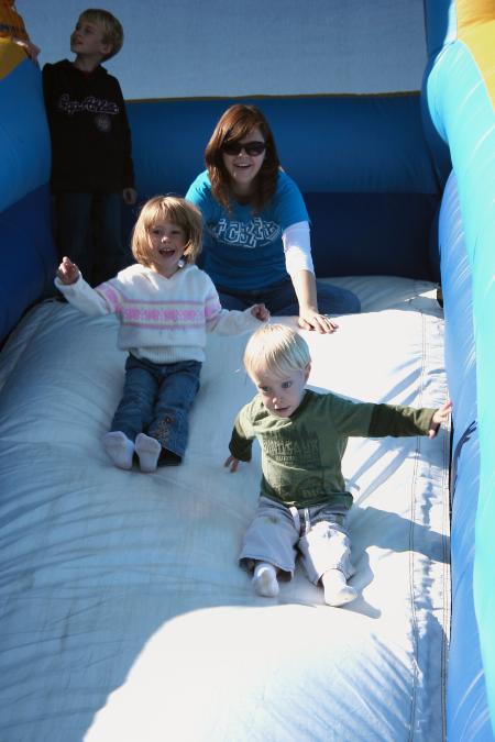 S.T.E.A. member Sarah Johnson supervises the inflatable slide during Homecoming's Arts in the Park. - Photo by Kristi McMurry Woody