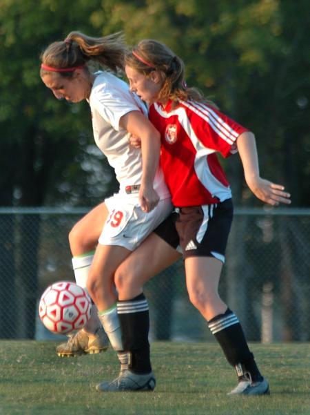 Lady Bulldog Sophomore Cara Pasley, of Jonesboro, Ark., uses some clever footwork to dodge a 
player from the opposing team from Lyon College.  The Bulldogs won 5-0.  - Photo by Neisha Fuson