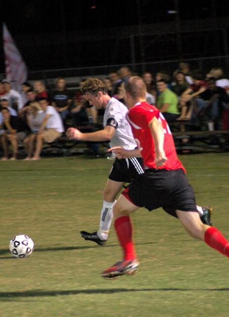 Senior Bulldog Benny Crozier drives past Lyon College’s Daniel Young. The Bulldogs shut out Lyon, 4–0. 
 - Photo by Matthew Diggs