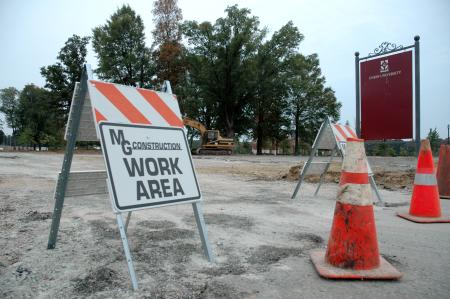 Construction crews clear and level the ground behind Coburn in order to prepare for the new expansions set for the dining hall. 
 - Photo by Matt Elia