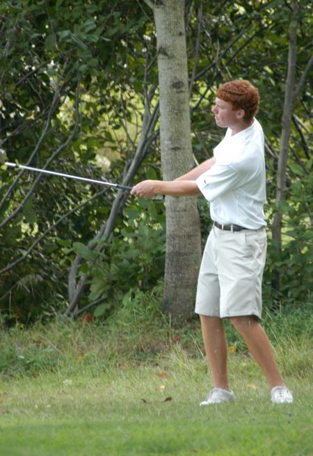 Tyler Lay follows through after chipping from the rough. - Photo by Steven Aldridge
