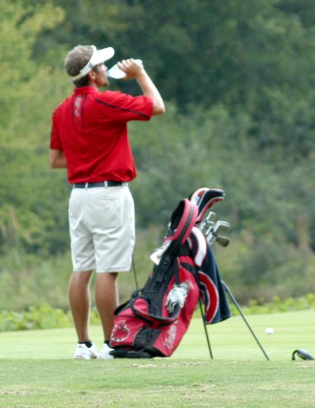 Gary Glapa takes a drink of water between shots as he plays his round at Falcon Ridge. - Photo by Steven Aldridge