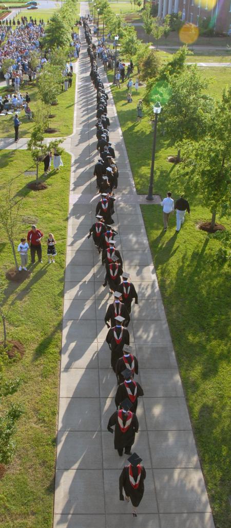 The long line of students walk out to the great lawn to receive their degrees. Dr. David S. Dockery, the university president, was the keynote speaker for the event, in which 400 students received degrees on the university’s Great Lawn. That brings to more than 950 the number of Union graduates from the class of 2008 – the largest class in Union’s history. - Photo by Morris Abernathy