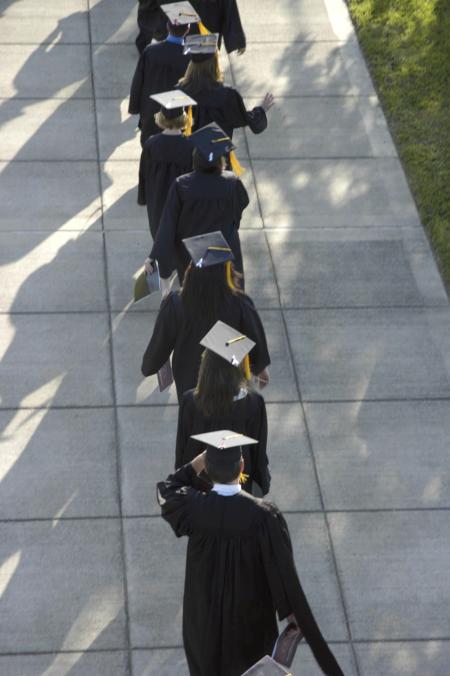 Students wore ribbons on their mortar boards to commemorate completion of the spring semester. A tornado struck the campus Feb. 5, shutting down the university for two weeks and creating doubt that the academic year would conclude on time. - Photo by Jordan Buie