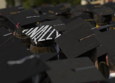 Students showed their excitement about finally being able to graduate, some shouted and cheered, while others spelled out their glee. - Photo by Jordan Buie