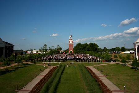 Graduates file into their seats during the Spring 2008 graduation ceremony.  The ceremony was held on the Great Lawn, between Jennings Hall, White Hall and Miller Tower.  Off in the distance, attendees could see the construction of the new dorms. - Photo by Kristi McMurry Woody