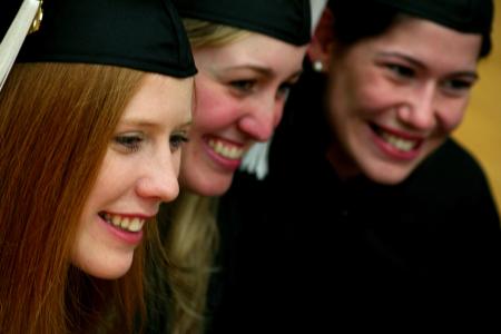 Abby Carpenter, history major, joins Katie Watson and Sarah Santiago, teaching English as a second language majors, in the Fred Delay gymnasium before graduation ceremonies. - Photo by Kristi McMurry Woody