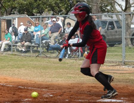 Michelle Albonetti puts the ball in play as she takes off for first base. - Photo by Steven Aldridge