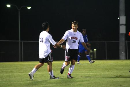 Rafa Rodriguez, sophomore, congratulates his teammate Cooper Rawls, freshman, after a play in Union's game against Rust College.  The Bulldogs won 17-0.

 - Photo by Kristi McMurry Woody