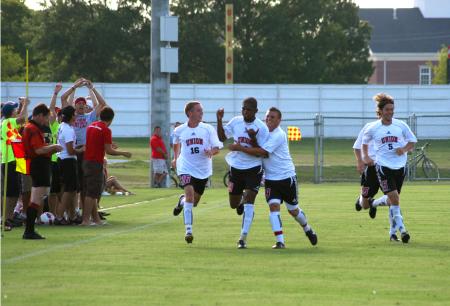 Darlan Rocha's teammates congratulate him on his goal in a game against Oklahoma Baptist University. - Photo by Kristi McMurry Woody