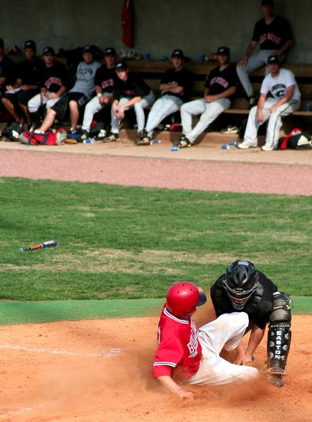 Josh Holman, senior physical education and health major, slides safely into home as the catcher tries to tag him out.  The Bulldogs beat Crichton 12-5. - Photo by Kristi McMurry Woody