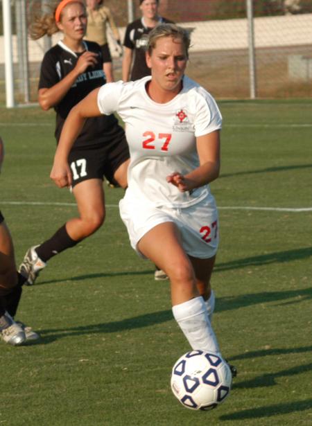 Katelin Dirksen moves the ball quickly away from defenders. - Photo by Tommy Sadler