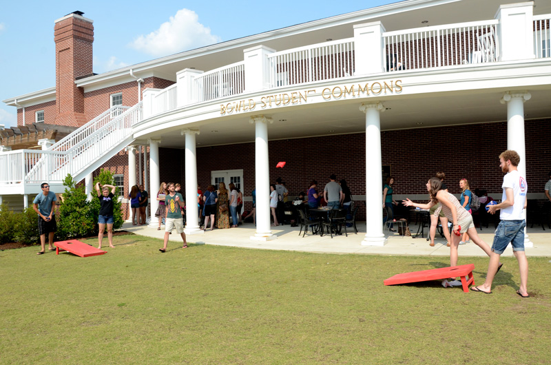 students playing game by the back porch