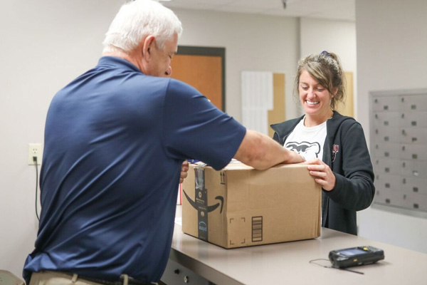 Staff member helping a student in Mailing Services