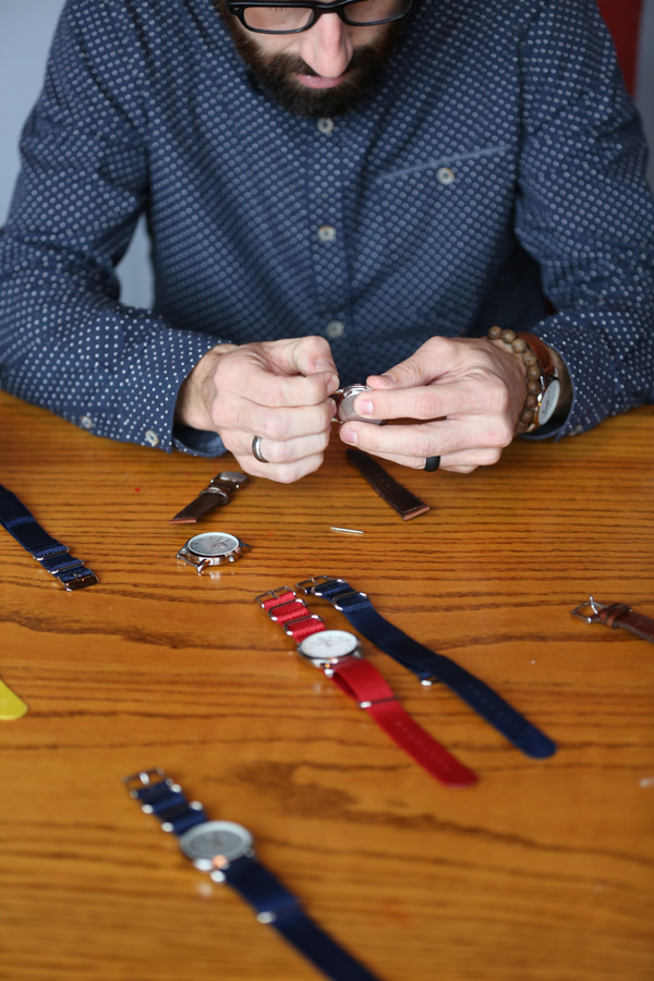 Matt Nason, owner of Generation Watches, changes the band on one of the watches he and his brother designed.