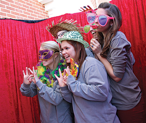 A group of students enjoy the photo booth available at the Union Strong event during homecoming weekend.