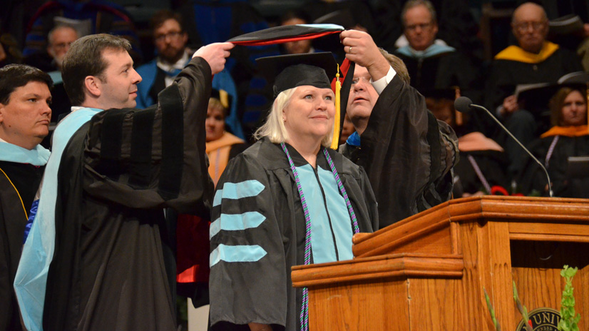 Jan Baldwin receives her doctoral hood during fall graduation.