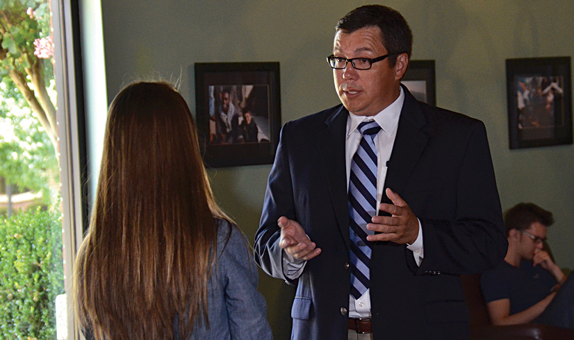 Andrew Tiger talking with student
