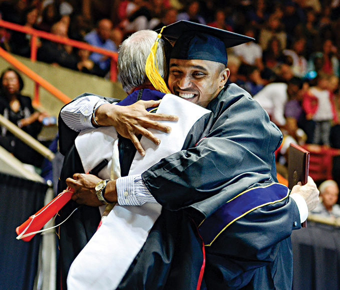Dr. Dockery receives a hug from a excited graduate